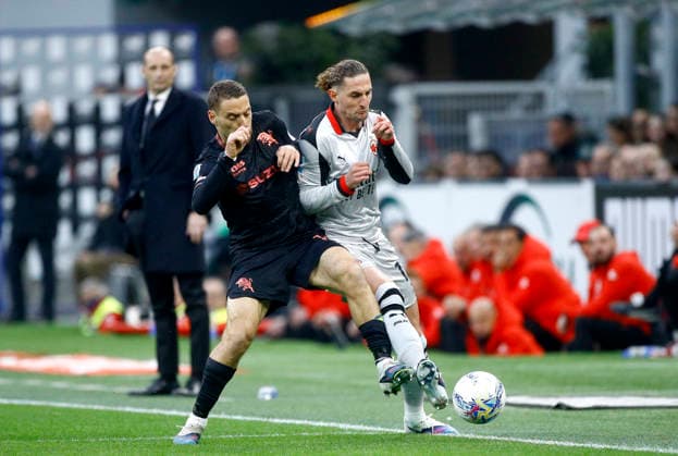 MILAN, ITALY - MARCH 21: Adrien Rabiot of AC Milan competes for the ball with Nikola Vlasic of Torino FC ,during the Serie A match between AC Milan and Torino FC at Giuseppe Meazza Stadium on March 21, 2026 in Milan, Italy.  Copyright: xMBxMediax