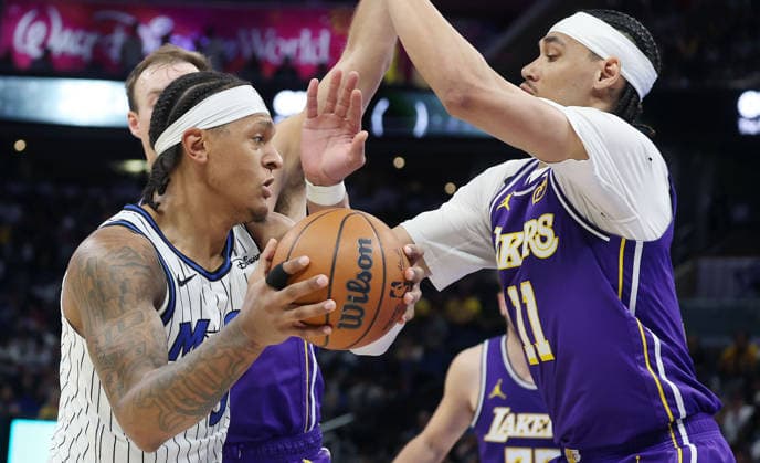 March 21, 2026, Orlando, Fl - Florida, USA: The Orlando Magic s Paolo Banchero, left, tries to get past the Los Angeles Lakers Jaxon Hayes (11) at the Kia Center on Saturday, March 21, 2026, in Orlando, Florida. Orlando USA - ZUMAm67_ 20260321_zaf_m67_009 Copyright: xStephenxM.xDowellx