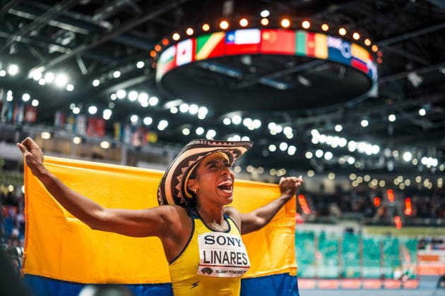KUJAWY POMORZE, POLAND - MARCH 22: Natalia Linares (COL) celebrates her third place in the womens long jump with flag and hat at the World Athletics Indoor Championships Kujawy Pomorze 26 at Kujawsko-Pomorska Arena Torun on March 22, 2026 in Kujawy Pomorze, Poland. Copyright: xUlfxSchillerx
