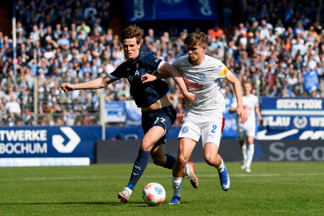 Oliver Olsen VfL Bochum and Frederik Roslyng Holstein Kiel battle for the ball during the 2 Bundesliga match between VfL Bochum and Holstein Kiel, Vonovia Ruhrstadion on March 22, 2026 in Bochum, Germany, Germany Photo by Max Maiwald DeFodi Images Oliver Olsen VfL Bochum and Frederik Roslyng Holstein Kiel battle for the ball during the 2 Bundesliga match between VfL Bochum and Holstein Kiel at Vonovia Ruhrstadion on March 22, 2026 in Bochum, Germany Photo by Max Maiwald DeFodi Images Photo by Max Maiwald DeFodi Images