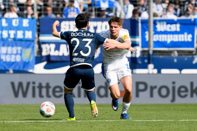 Koji Miyoshi VfL Bochum and Frederik Roslyng Holstein Kiel battle for the ball during the 2 Bundesliga match between VfL Bochum and Holstein Kiel, Vonovia Ruhrstadion on March 22, 2026 in Bochum, Germany, Germany Photo by Max Maiwald DeFodi Images Koji Miyoshi VfL Bochum and Frederik Roslyng Holstein Kiel battle for the ball during the 2 Bundesliga match between VfL Bochum and Holstein Kiel at Vonovia Ruhrstadion on March 22, 2026 in Bochum, Germany Photo by Max Maiwald DeFodi Images Photo by Max Maiwald DeFodi Images