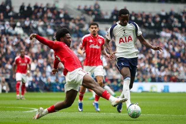 Pape Matar Sarr of Tottenham Hotspur is challenged by Ola Aina of Nottingham Forest Tottenham Hotspur v Nottingham Forest, Football, Premier League, Tottenham Hotspur Stadium, London, UK - 22 03 2026 EDITORIAL USE ONLY No use with unauthorised audio, video, data, fixture lists (outside the EU), club league logos or live services. Online in-match use limited to 45 images (+15 in extra time). No use to emulate moving images. No use in betting, games or  Copyright: xAnthonyxHanc Shutterstockx 16785849r