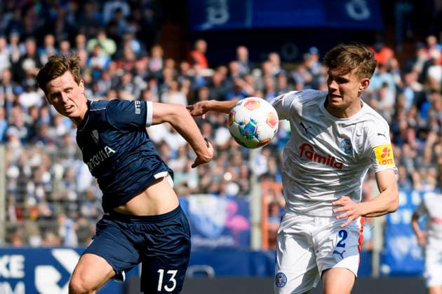 Oliver Olsen VfL Bochum and Frederik Roslyng Holstein Kiel battle for the ball during the 2 Bundesliga match between VfL Bochum and Holstein Kiel, Vonovia Ruhrstadion on March 22, 2026 in Bochum, Germany, Germany Photo by Max Maiwald DeFodi Images Oliver Olsen VfL Bochum and Frederik Roslyng Holstein Kiel battle for the ball during the 2 Bundesliga match between VfL Bochum and Holstein Kiel at Vonovia Ruhrstadion on March 22, 2026 in Bochum, Germany Photo by Max Maiwald DeFodi Images Photo by Max Maiwald DeFodi Images