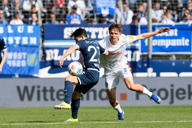 Koji Miyoshi VfL Bochum and Frederik Roslyng Holstein Kiel battle for the ball during the 2 Bundesliga match between VfL Bochum and Holstein Kiel, Vonovia Ruhrstadion on March 22, 2026 in Bochum, Germany, Germany Photo by Max Maiwald DeFodi Images Koji Miyoshi VfL Bochum and Frederik Roslyng Holstein Kiel battle for the ball during the 2 Bundesliga match between VfL Bochum and Holstein Kiel at Vonovia Ruhrstadion on March 22, 2026 in Bochum, Germany Photo by Max Maiwald DeFodi Images Photo by Max Maiwald DeFodi Images