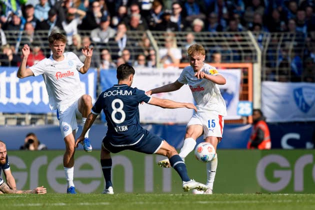 Frederik Roslyng Holstein Kiel , Kjell Waetjen VfL Bochum and Kasper Davidsen Holstein Kiel battle for the ball during the 2 Bundesliga match between VfL Bochum and Holstein Kiel, Vonovia Ruhrstadion on March 22, 2026 in Bochum, Germany Photo by Max Maiwald DeFodi Images Frederik Roslyng Holstein Kiel , Kjell Waetjen VfL Bochum and Kasper Davidsen Holstein Kiel battle for the ball during the 2 Bundesliga match between VfL Bochum and Holstein Kiel at Vonovia Ruhrstadion on March 22, 2026 in Bochum, Germany Photo by Max Maiwald DeFodi Images Photo by Max Maiwald DeFodi Images
