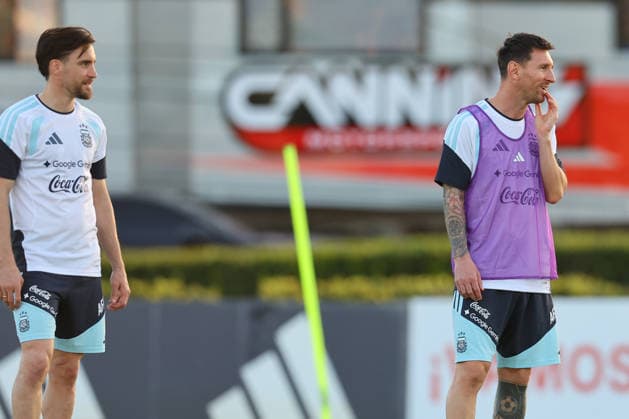Argentine forward Lionel Messi R gestures next his teammate defender Nicolas Tagliafico during a training session in Ezeiza, Buenos Aires Province, on March 25, 2026, ahead of the 2026 FIFA World Cup friendly matches against Mauritania and Zambia EZEIZA ARGENTINA Copyright: xALEJANDROxPAGNIx