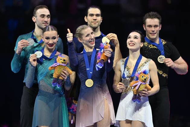 World Figure skating, Eiskunstlauf Championships, pairs - free skating, in Prague, Czech Republic, on March 26, 2026. On the podium from left: second Anastasiia Metelkina and Luka Berulava from Georgia, first Minerva Fabienne Hase and Nikita Volodin from Germany and third Lia Pereira and Trennt Michaud from Canada. (CTKxPhoto MichaelaxRihova) CTKPhotoP2026032610477  CTKPhotoP2026032610477