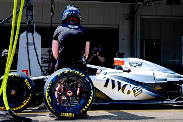 SUZUKA Mechanic sits on a wheel next to the car of Formula 1 driver Sergio Pï¿½rez or Cadillac Formula 1 Team during the Formula 1 Japan Suzuka free practice at the Suzuka Formula 1 circuit on March 27, 2025 in Suzuka, Japan Photo by DeFodi Images