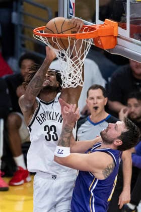 March 27, 2026, Los Angeles, California, USA: Brooklyn NetsÃ¢â‚¬â ¢ Nic Claxton (33) dunks against Los Angeles LakersÃ¢â‚¬â ¢ Luka DonÄÂiÄ¡ (77) during an NBA, Basketball Herren, USA basketball game at Crypto.com Arena on Friday, March 27, 2026 in Los Angeles. NBA 2026: Nets Vs Lakers  - ZUMAc68_ 20260327_zaf_c68_016 Copyright: xRingoxChiux