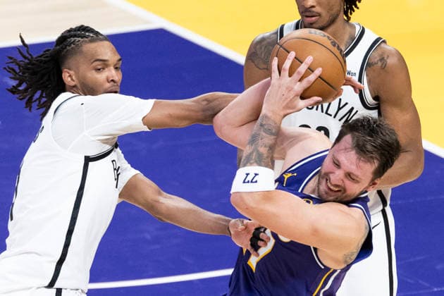 March 27, 2026, Los Angeles, California, USA: Los Angeles LakersÃ¢â‚¬â ¢ Luka DonÄÂiÄ¡ (77) is defended by Brooklyn NetsÃ¢â‚¬â ¢ Ziaire Williams (1) during an NBA, Basketball Herren, USA basketball game at Crypto.com Arena on Friday, March 27, 2026 in Los Angeles. NBA 2026: Lakers 116:99 Nets  - ZUMAc68_ 20260327_zaf_c68_046 Copyright: xRingoxChiux