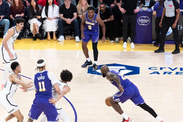 March 27, 2026, Los Angeles, California, United States: Los Angeles Lakers™ Bronny James (9) watches as LeBron James (23) drives against the Brooklyn Nets during an NBA, Basketball Herren, USA basketball game at Crypto.com Arena on Friday, March 27, 2026 in Los Angeles. NBA 2026: Lakers 116:99 Nets - 27 Mar 2026  - ZUMAs197 20260327_aaa_s197_554 Copyright: xRingoxChiux
