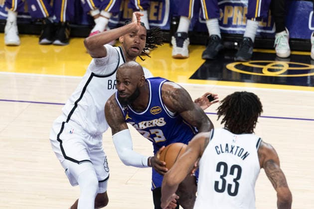 March 27, 2026, Los Angeles, California, United States: Los Angeles Lakers™ LeBron James (23) drives between Brooklyn Nets™ Ziaire Williams (1) and Brooklyn Nets™ Nic Claxton (33) during an NBA, Basketball Herren, USA basketball game at Crypto.com Arena on Friday, March 27, 2026 in Los Angeles. NBA 2026: Lakers 116:99 Nets - 27 Mar 2026  - ZUMAs197 20260327_aaa_s197_556 Copyright: xRingoxChiux