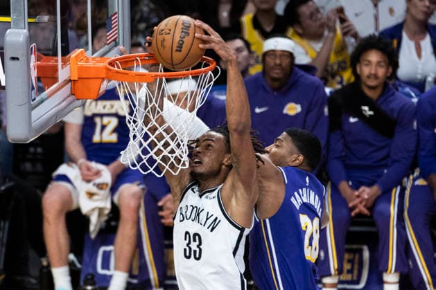 March 27, 2026, Los Angeles, California, United States: Brooklyn Nets™ Nic Claxton (33) dunks under pressure from Los Angeles Lakers™ Rui Hachimura (28) during an NBA, Basketball Herren, USA basketball game at Crypto.com Arena on Friday, March 27, 2026 in Los Angeles. NBA 2026: Lakers 116:99 Nets - 27 Mar 2026  - ZUMAs197 20260327_aaa_s197_563 Copyright: xRingoxChiux