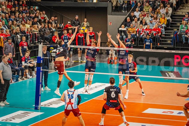 Volleyball Men Season 2025 2026 Volleyball Bundesliga Playoff Quarterfinals SVG Lüneburg vs WWK Volleys Herrsching 28 03 2026 Laurenz Welsch 12 WWK Volleys Herrsching against the block of Santeri Välimaa 12 SVG Lüneburg and Cole Young 8 SVG Lüneburg