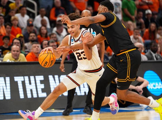 March 28, 2026, Houston, Texas, USA: Illinois guard KEATON WAGLER (23) moves the ball against Iowa forward CAM MANYAWU (3) during the NCAA, College League, USA MenÃ¢â‚¬â ¢s Basketball Tournament Elite Eight game between the Illinois Fighting Illini and the Iowa Hawkeyes on March 28, 2026 in Houston, Texas. Illinois won, 71-59. NCAA Basketball 2026: Illinois 71:59 Iowa  - ZUMAc201 20260328_zap_c201_059 Copyright: xScottxColemanx