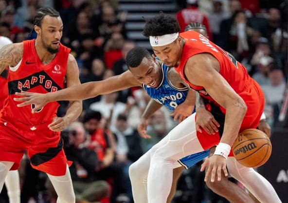 March 29, 2026, Toronto, On, Canada: Toronto Raptors forward Scottie Barnes (right) strips the ball from Orlando Magic forward Jamal Cain (8) as Raptors guard A.J. Lawson (0) helps during first half NBA, Basketball Herren, USA action in Toronto on Sunday March 29, 2026. Canada News - March 29, 2026  - ZUMAc35_ 20260329_zaf_c35_179 Copyright: xFrankxGunnx