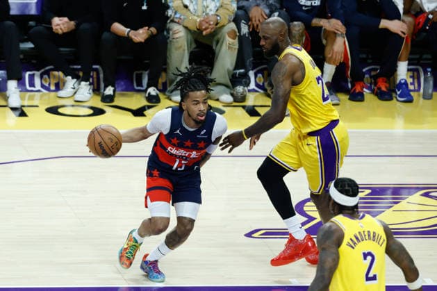 LOS ANGELES, CA - MARCH 30: Washington Wizards guard Sharife Cooper (13) slips past Los Angeles Lakers forward LeBron James (23) during the Washington Wizards vs Los Angeles Lakers game on March 30, 2026, at Crypto.com Arena in Los Angeles, CA. (Photo by Jevone Moore Icon Sportswire) NBA, Basketball Herren, USA MAR 30 Washington Wizards at Los Angeles Lakers EDITORIAL USE ONLY Icon20260330012