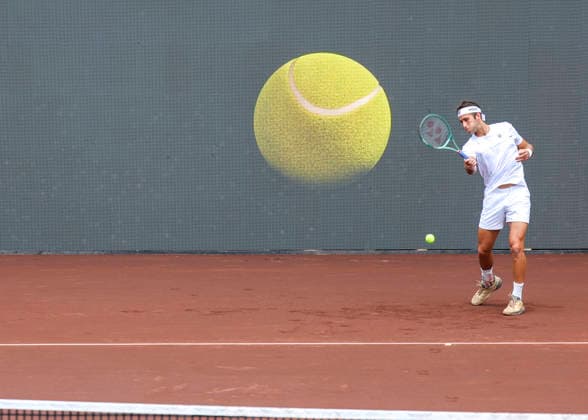 HOUSTON, TX - APRIL 01: Graphic of large tennis ball appears behind Tomas Martin Etcheverry (ARG) as he warms up for the singles round of 16 match at the Men™s Clay Court Championship on April 1, 2026 at River Oaks Country Club in Houston(Photo by Leslie Plaza Johnson Icon Sportswire) TENNIS: APR 01 US Men s Clay Court Championship EDITORIAL USE ONLY Icon260401001