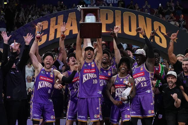 NBL KINGS 36ERS, Xavier Cooks of the Kings lifts The Larry O™Brien Championship Trophy as his side are crowned champions during NBL grand final, game five, Sydney Kings v Adelaide 36ers, at Qudos Bank Arena in Sydney, Sunday, April 5, 2026. ( NO ARCHIVING, EDITORIAL USE ONLY SYDNEY NEW SOUTH WALES AUSTRALIA  Copyright: xROBBIExSTEPHENSONx 20260405161884859790
