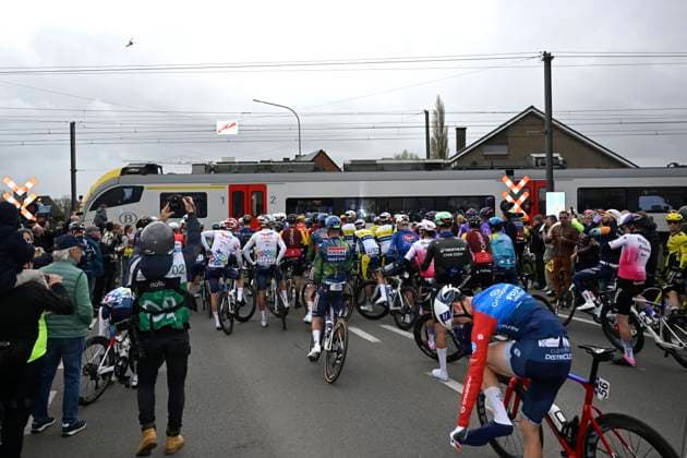 Sport Bilder des Tages Ronde van Vlaanderen 2026 Cycling Race OUDENAARDE, BELGIUM - APRIL 05 : Part of the peloton is stopped by a passing train during the 110th edition of Ronde van Vlaanderen an UCI World Tour 1.UWT one day cycling road race for Men Elite of 271 km with start in Antwerpen and finish in Oudenaarde on April 5, 2026 in Oudenaarde, Belgium, 05 04 2026 ( Motordriver Guy De Vuyst - Oudenaarde Belgium  Copyright: xNicoxVereeckenx