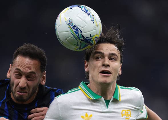Milan, Italy, 5th April 2026. Hakan Calhanoglu of FC Internazionale battles for possession with Niccolo Pisilli of AS Roma during the Internazionale vs AS Roma Serie A match at Giuseppe Meazza, Milan. Picture credit should read: Jonathan Moscrop Sportimage EDITORIAL USE ONLY. No use with unauthorised audio, video, data, fixture lists, club league logos or live services. Online in-match use limited to 120 images, no video emulation. No use in betting, games or single club league player publications. SPI_011_JM_INTER_ROMA SPI-4643-0011