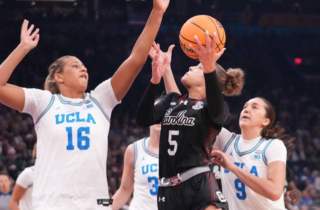 South Carolina guard Tessa Johnson (5) tries to shoot as she is guarded by UCLA forward Sienna Betts (16) and guard Lena Bilic (9) in the first half of the Finals of the 2026 NCAA, College League, USA Women s Basketball Tournament at Mortgage Matchup Center in Phoenix, Arizona, on Sunday, April 5, 2026.  AZP20260405916 DARRYLxWEBB