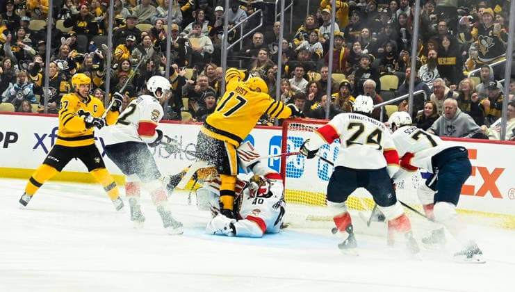 Pittsburgh Penguins right wing Bryan Rust (17) scores early in the third period before colliding with Florida Panthers goaltender Sergei Bobrovsky (72) at PPG Paints Arena in Pittsburgh on Sunday, April 5, 2026. Pittsburgh Penguins right wing Bryan Rust (17) recorded his 500th point on an assist in the first period.  PIT2026040512 ARCHIExCARPENTER