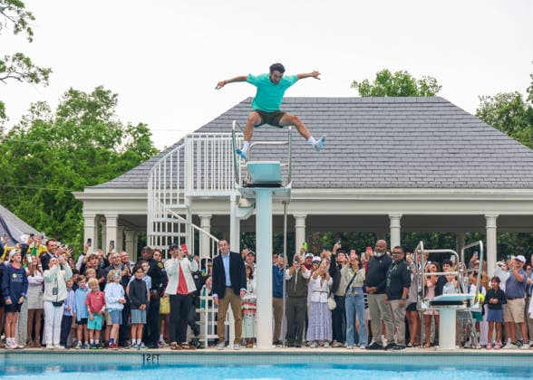 HOUSTON, TX - APRIL 05: Andres Andrade (ECU) jumps in the pool as part of the victory tradition after the doubles finals of the Men™s Clay Court Championship on April 5, 2026 at River Oaks Country Club in Houston, Texas. (Photo by Leslie Plaza Johnson Icon Sportswire) TENNIS: APR 05 US Men s Clay Court Championship EDITORIAL USE ONLY Icon260405109
