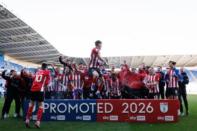 Lincoln City players celebrate their promotion to the Sky Bet Championship Reading v Lincoln City, Sky Bet League One, Football, Select Car Leasing Stadium, Reading, UK - 06 Apr 2026Reading Select Car Leasing Stadium United Kingdom EDITORIAL USE ONLY No use with unauthorised audio, video, data, fixture lists, club league logos or live services. Online in-match use limited to 120 images, no video emulation. No use in betting, games or single club league player publications. Copyright: xSimonxDael Shutterstockx 16811828as