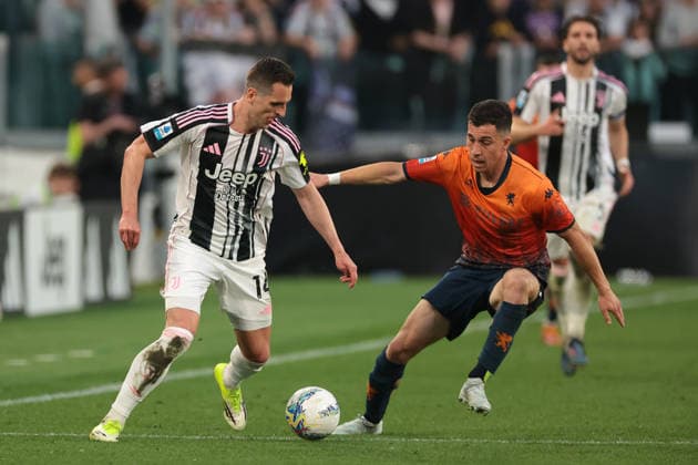 Turin, Italy, 6th April 2026. Arkadiusz Milik of Juventus takes on Patrizio Masini of Genoa CFC during the Juventus vs Genoa Serie A match at Allianz Stadium, Turin. Picture credit should read: Jonathan Moscrop Sportimage EDITORIAL USE ONLY. No use with unauthorised audio, video, data, fixture lists, club league logos or live services. Online in-match use limited to 120 images, no video emulation. No use in betting, games or single club league player publications. SPI_083_JM_JUVE_GENOA SPI-4644-0083