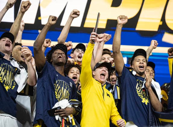 April 6, 2026, Indianapolis, Indiana, USA: Michigan head coach Dusty May celebrates with his team after defeating the UConn Huskies for the NCAA, College League, USA Mens Basketball Championship, 69-63. Monday, April 7, 2026. Indianapolis USA - ZUMAr44_ 20260406_zsp_r44_003 Copyright: xThomasxJ.xRussox