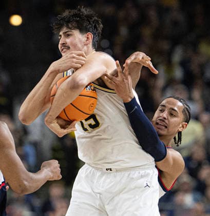 April 6, 2026, Indianapolis, Indiana, USA: Michigans Adam Mara fights off UConns Jayden Ross during second half action of the NCAA, College League, USA Mens Basketball Championship. Michigan went on to win 69-63. Monday, April 7, 2026. Indianapolis USA - ZUMAr44_ 20260406_zsp_r44_016 Copyright: xThomasxJ.xRussox