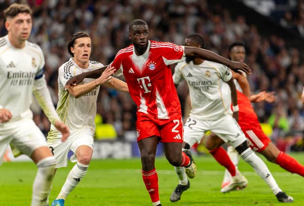 07 04 2026, Football UEFA Champions League 2025 2026 quarter-finals, Real Madrid FC Bayern Munich, at Estadio Bernabeu in Madrid Spain , from left Federico Valverde Real Madrid vs Dayot Upamecano FC Bayern Munich