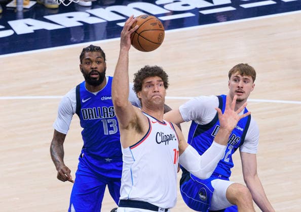 April 7, 2026, Inglewood, California, USA: Brook Lopez 11 of the Los Angeles Clippers wins a rebound from Naji Marshall 13 and Cooper Flagg 32 of the Dallas Mavericks during a 2026 NBA, Basketball Herren, USA regular season game on Tuesday April 7, 2026 at Intuit Dome Arena in Inglewood, California. JAVIER ROJAS PI Inglewood USA - ZUMAp124 20260407_zaa_p124_019 Copyright: xJavierxRojasx