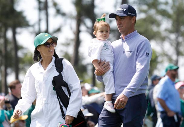 Justin Thomas, his wife Jillian Thomas and their daughter Molly Grace Thomas walk down a fairway as they take part in the 2026 Masters golf tournament Par 3 Contest at Augusta National Golf Club in Augusta, Georgia, on Wednesday, April 8, 2026. The 2026 Masters Golf tournament begins on Thursday, April 9.  AUG20260408825 JOHNxANGELILLO