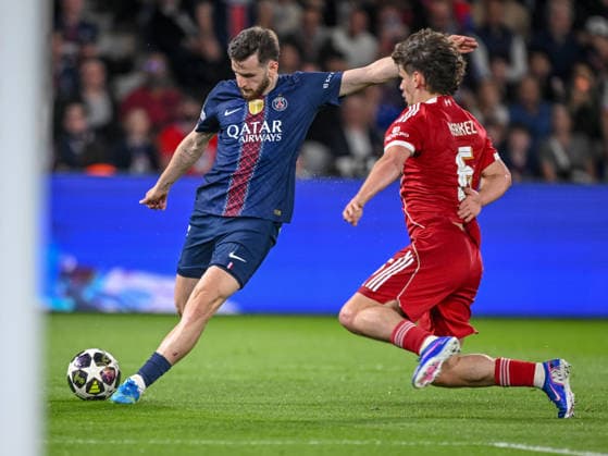 Khvicha Kvaratskhelia Paris Saint Germain FC and Milos Kerkez Liverpool FC battle for the ball during the UEFA Champions League 2025 26 Quarter Final First Leg match between Paris Saint Germain FC and Liverpool FC at Parc des Princes on April 8, 2026 in Paris, France Photo by Harry Langer DeFodi Images