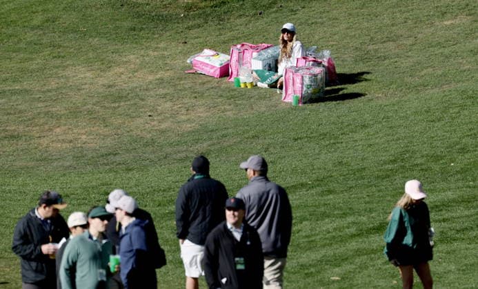 Golf 2026 Masters Tournament - Round 1 A patron sits among bags with various sorts of merchandise during Round 1 of the 2026 Masters tournament in August, Georgia, USA, 09 April 2026. Augusta United States  Copyright: xERIKxS.xLESSERx