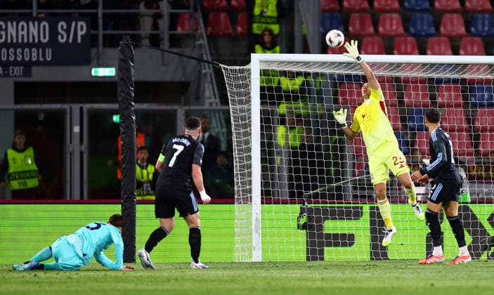 Emiliano Martinez of Aston Villa makes a save from Juan Miranda of Bologna. Bologna v Aston Villa, UEFA Europa League, Quarter Final, First Leg, Football, Renato Dall Ara Stadium, Bologna, Italy - 09 Apr 2026Bologna Renato Dall Ara Stadium Italy EDITORIAL USE ONLY No use with unauthorised audio, video, data, fixture lists, club league logos or live services. Online in-match use limited to 120 images, no video emulation. No use in betting, games or single club league player publications. Copyright: xJamesxMarsh Shutterstockx 16811867as