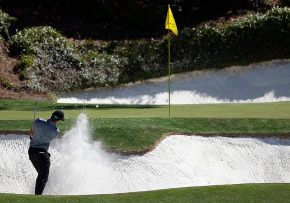 Aaron Rai of England hits out of a bunker on the 12th hole during the first day of the Masters Tournament at Augusta National Golf Club on Thursday, April 9, 2026, in Augusta, Georgia.  AUG20260409763 JOHNxANGELILLO