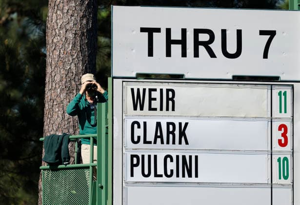 A scorekeeper keeps an eye on the action through binoculars on the second day of the Masters Tournament at Augusta National Golf Club on Friday, April 10, 2026, in Augusta, Georgia.  AUG20260410814 JOHNxANGELILLO