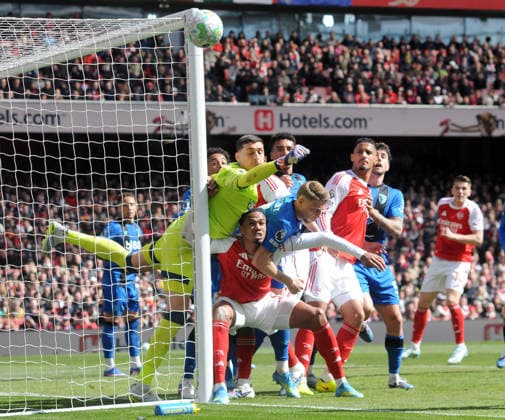 Football - 2025 2026 Premier League - Arsenal vs. AFC Bournemouth - Emirates Stadium - Saturday 11th April 2026 Bournemouth goalkeeper, Djordje Petrovic punches just clear of the post, under pressure from Arsenal™s Gabriel 