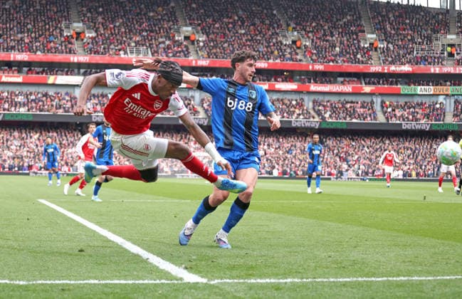Noni Madueke (A) Marcos Senesi (AFC B) at the Arsenal v AFC Bournemouth EPL match, at the Emirates Stadium, London, UK on 11th April, 2026. 