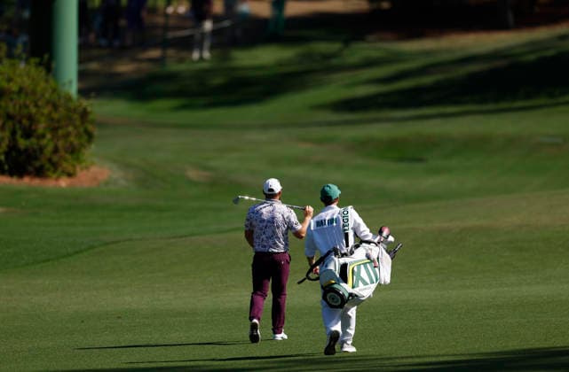 Tyrrell Hatton of England and his caddie walk up the 10th fairway after his approach shot to the green during the third round of the Masters Tournament at Augusta National Golf Club on Saturday, April 11, 2026, in Augusta, Georgia.  AUG20260411821 JOHNxANGELILLO
