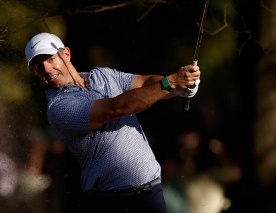 Rory McIlroy of Northern Ireland hits out of the pine straw on the 13th hole during the third round of the Masters Tournament at Augusta National Golf Club on Saturday, April 11, 2026, in Augusta, Georgia.  AUG202604111002 JOHNxANGELILLO