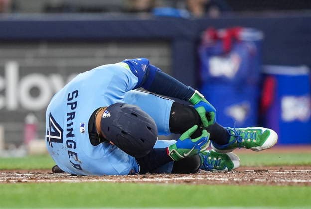 April 11, 2026, Toronto, On, CANADA: Toronto Blue Jays designated hitter George Springer falls to the ground after taking a foul ball of his foot while playing against he Minnesota Twins during third inning American League MLB, Baseball Herren, USA baseball action in Toronto on Saturday, April 11, 2026. Canada News - April 11, 2026  - ZUMAc35_ 20260411_zaf_c35_130 Copyright: xNathanxDenettex