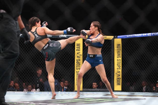 April 11, 2026, Miami, Fl, USA: Miami, FLORIDA Ã¢â‚¬ APRIL 11: (L-R) Loopy GodoÂ­nez kicks Tatiana Suarez in a Women s Strawweight bout during UFC 327 at Kaseya Center on April 11, 2026 in Miami, FL. UFC 327: ProchoÂ¡Zka Vs. Ulberg  - ZUMAr187 20260411_zsp_r187_004 Copyright: xJustinxRenfroex