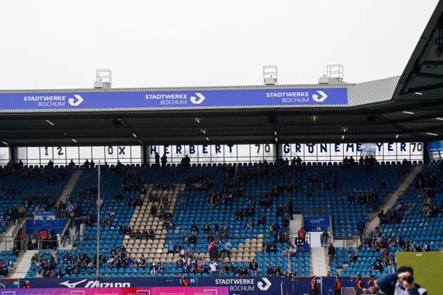 Germany Soccer 2 Bundesliga 2025 2026, 29 Matchday VfL Bochum vs Eintracht Braunschweig Vonovia Ruhrstadion Bochum, Germany, Europe, Tribune, Long shot, Spectators, Fans, Seats, Stadium interior, Sports stadium, Home crowd, Banner, lettering, Herbert Groenemeyer, 70th birthday, anniversary, tribute, Ruhr area, culture, club environment, atmosphere, match day, event, public, blue and white, advertising banner, Stadtwerke Bochum, advertising, economy, structure, frontal perspective Copyright: xJOERANxSTEINSIEKx