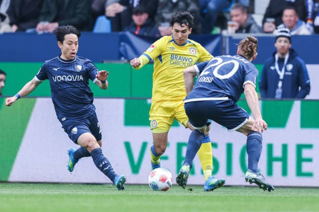 Soccer 2 Bundesliga 29 Matchday VfL Bochum Eintracht Braunschweig on 12 04 2026 at Vonovia Ruhrstadion in Bochum Koji Miyoshi Bochum , left Johan Gomez Braunschweig , center Noah Loosli Bochum , right DFL regulations prohibit any use of photographs as image sequences and or quasi video xJRx