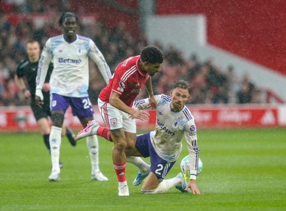 Nottingham, England, 12th April 2026. Morgan Gibbs White of Nottingham Forest tackled by Matty Cash of Aston Villa during the Nottingham Forest vs Aston Villa Premier League match at the City Ground, Nottingham. Picture credit should read: Andrew Yates Sportimage EDITORIAL USE ONLY. No use with unauthorised audio, video, data, fixture lists, club league logos or live services. Online in-match use limited to 120 images, no video emulation. No use in betting, games or single club league player publications. SPI_015_AY_Forest_Villa SPI-4682-0016