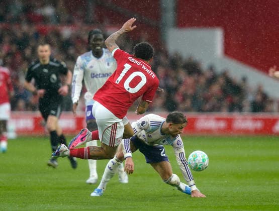 Nottingham, England, 12th April 2026. Morgan Gibbs White of Nottingham Forest tackled by Matty Cash of Aston Villa during the Nottingham Forest vs Aston Villa Premier League match at the City Ground, Nottingham. Picture credit should read: Andrew Yates Sportimage EDITORIAL USE ONLY. No use with unauthorised audio, video, data, fixture lists, club league logos or live services. Online in-match use limited to 120 images, no video emulation. No use in betting, games or single club league player publications. SPI_016_AY_Forest_Villa SPI-4682-0017